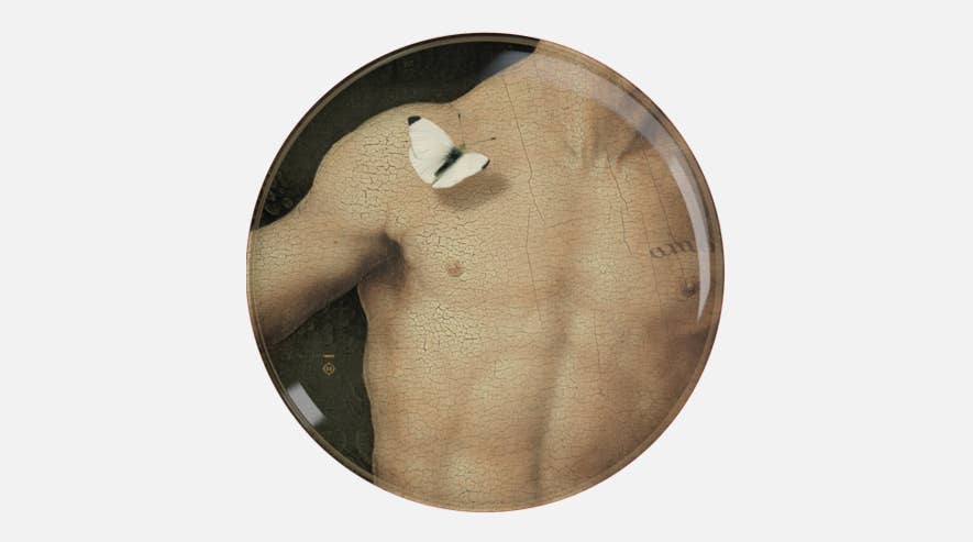 Single Eden plate showing a painted male chest and shoulder with a white butterfly on a crackled finish