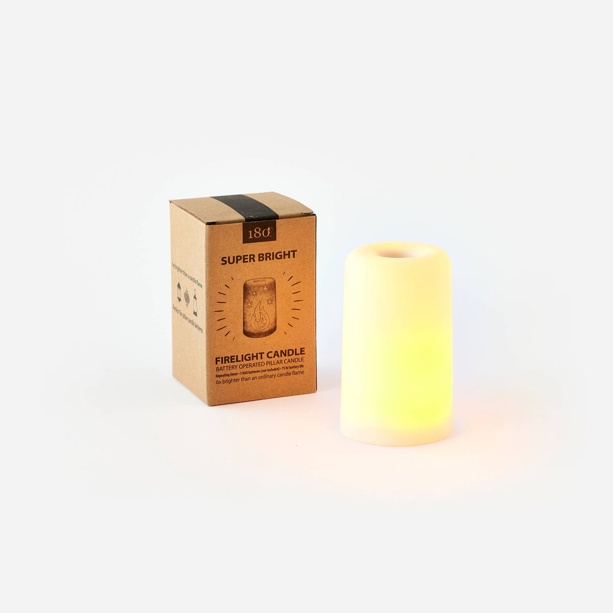 Flicker light LED pillar candle glowing warm white beside its kraft Firelight Candle gift box