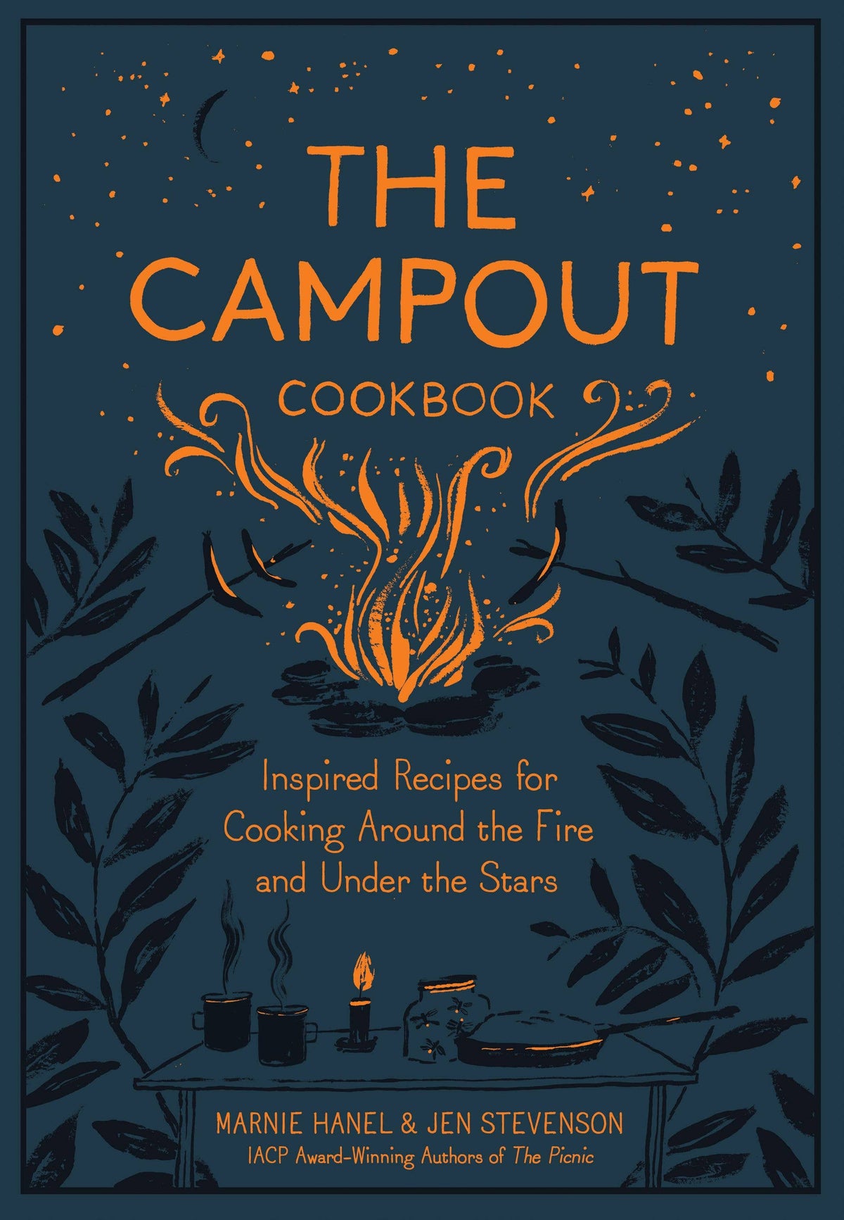 The Campout Cookbook cover close-up: campfire, roasting sticks and a camp table with mugs and a skillet