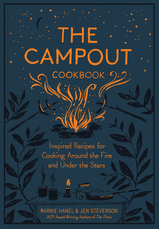 The Campout Cookbook cover close-up: campfire, roasting sticks and a camp table with mugs and a skillet