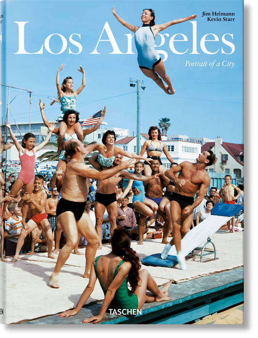 Closer view of the Los Angeles cover photo: muscle beach performers stacked in a human pyramid under blue sky