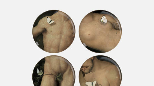 Close crop of the four Eden plates showing painted male torsos with butterflies and a leaf