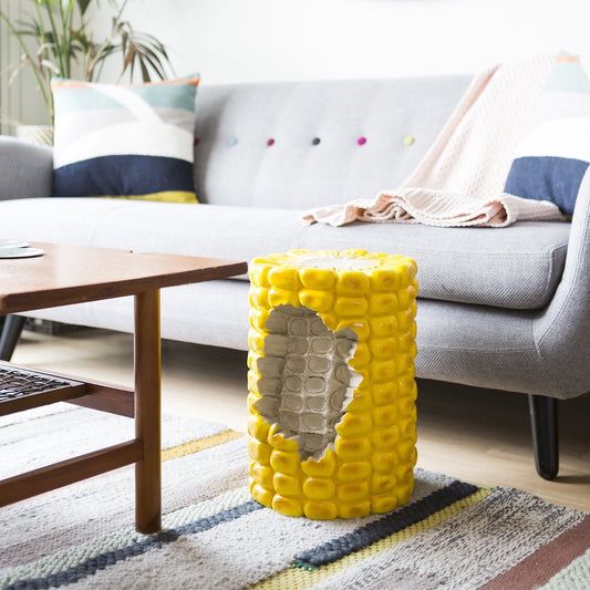 Oversize corn stool with section bitten out. In living room setting.