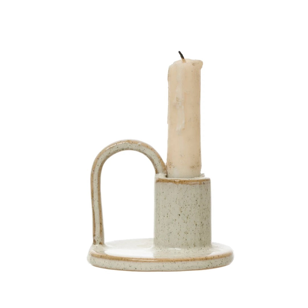 Stoneware taper holder with handle, reactive glaze with cream speckle.