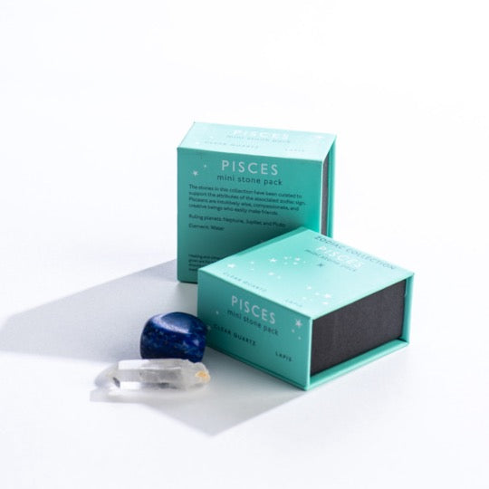 Pisces mini stone pack text on teal boxes with Pisces constellation pattern. Clear quartz and polished lapis stones in front.