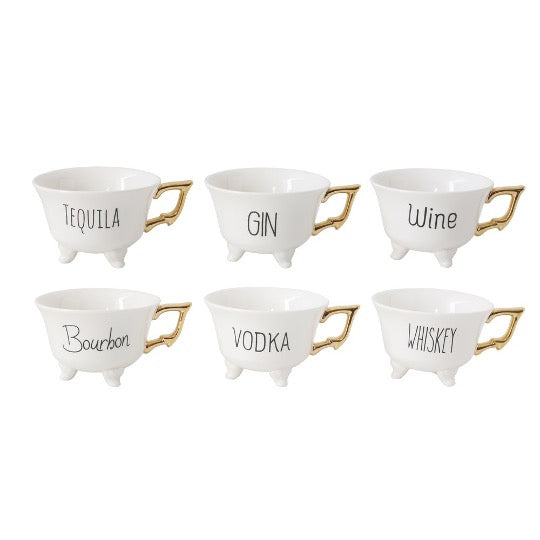 Six tea cups with gold handles. Each tea cup has black text with Wine, Vodka, Gin, Tequila, Whiskey, or Bourbon on side.