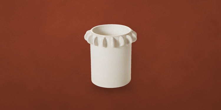 Ivory ceramic Reverie canister on a rust backdrop - new arrivals at Onederkam