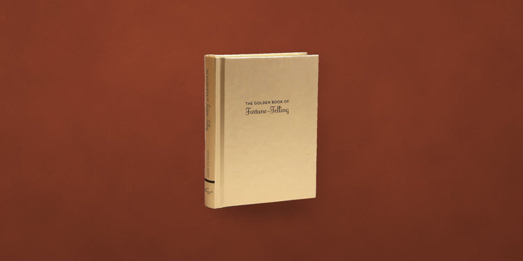 The Golden Book of Fortune Telling on a rust backdrop - Onederkam library