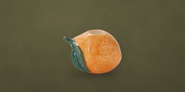 Orange ceramic fruit candleholder on an olive backdrop - Onederkam dining and entertaining
