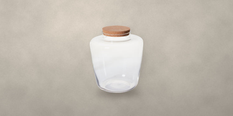 Glass message terrarium with cork lid on a stone backdrop - Onederkam terrariums