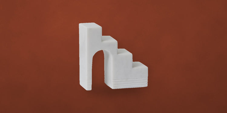 White geometric staircase sculpture on a rust backdrop - Onederkam gifts under $100
