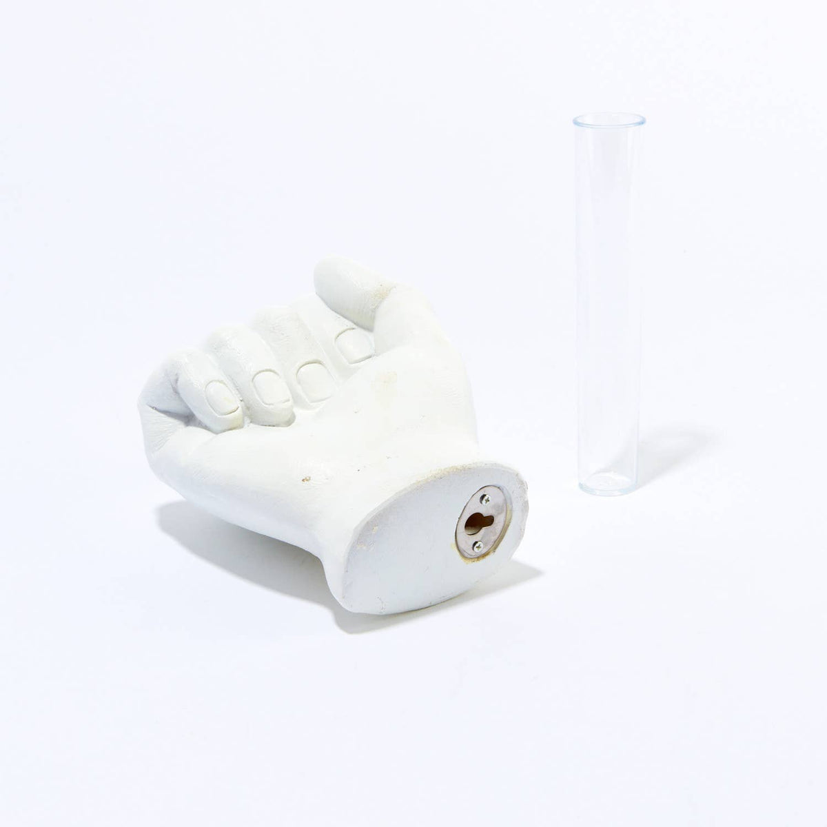 Vase hand sculpture laid on its side showing the keyhole mounting plate, glass tube beside it