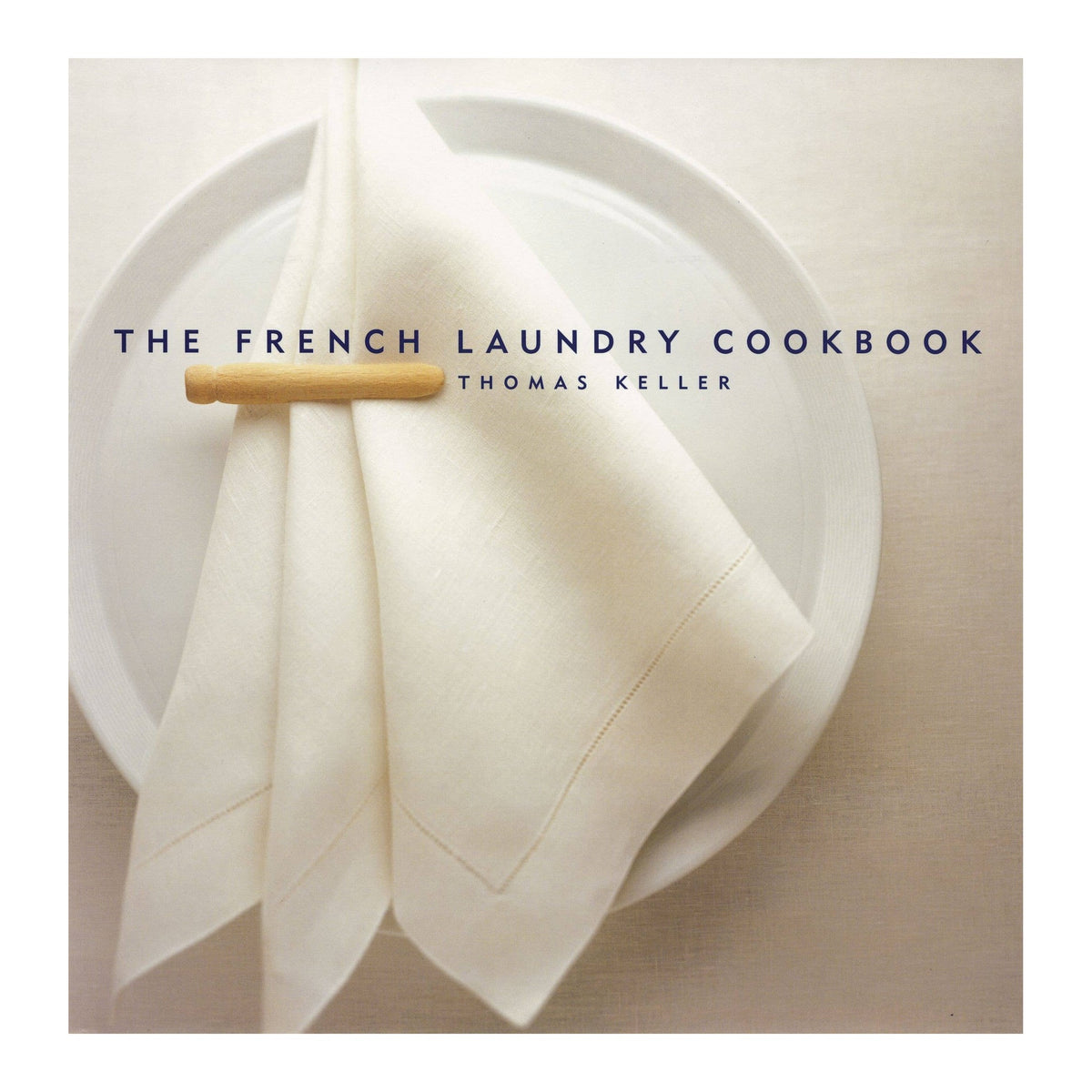 The French Laundry Cookbook by Thomas Keller, cover of a white napkin with a clothespin on a plate