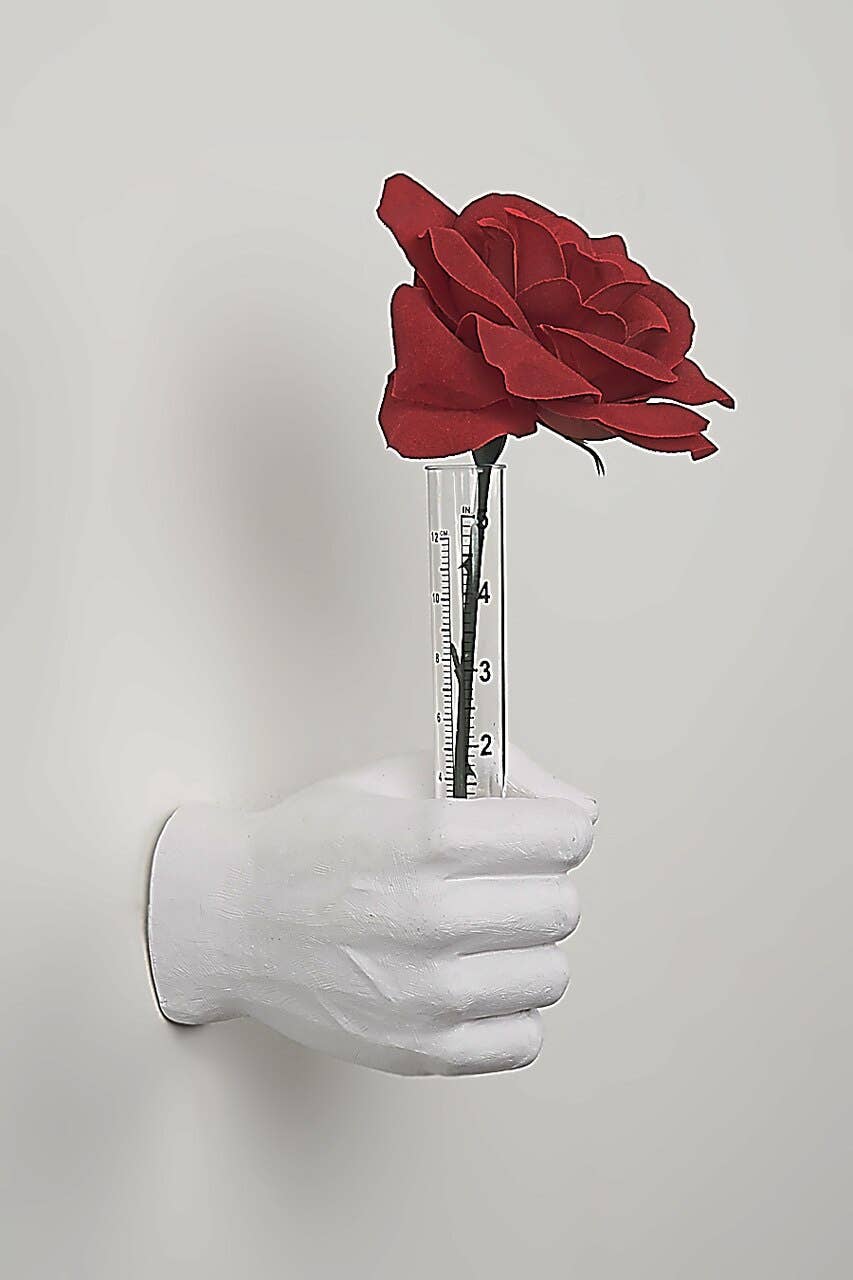 Vase hand wall sculpture gripping a clear measuring tube vase with a red rose, full side view