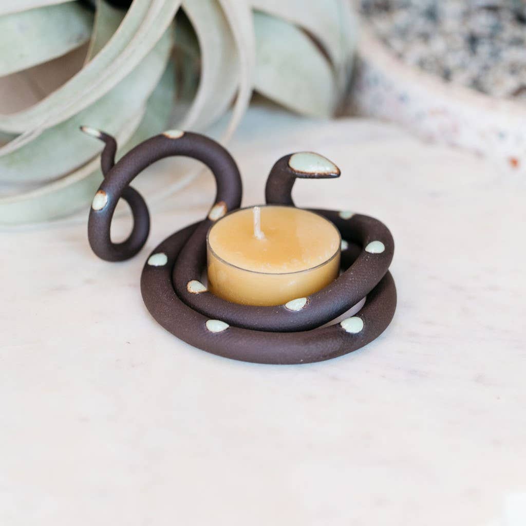 Dark brown ceramic snake tealight holder with pale mint spots and head, wrapped around a beeswax tealight