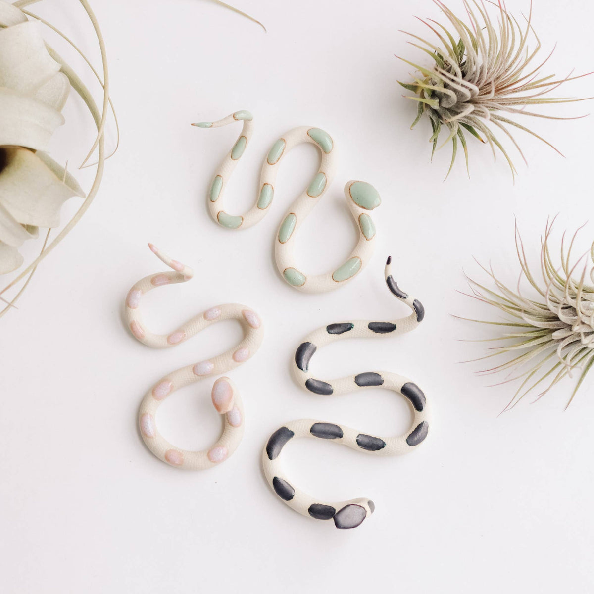 Ceramic snake set in light colors: cream with mint spots, cream with pink spots, cream with black bands