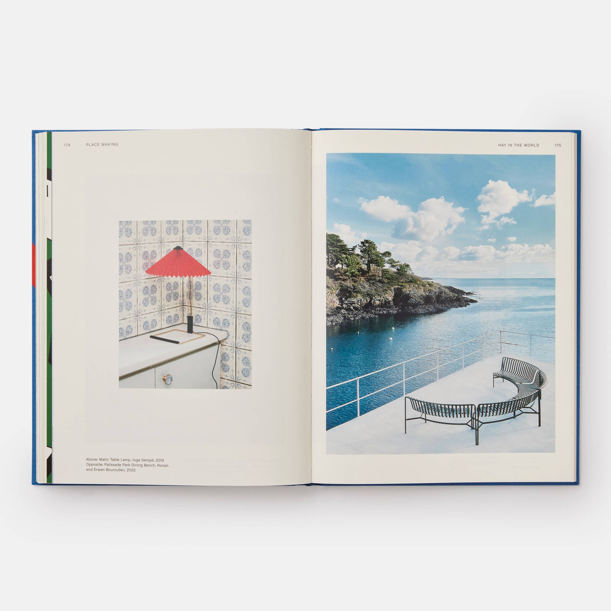 Open HAY book showing a red pleated lamp on tile and benches on a seaside terrace