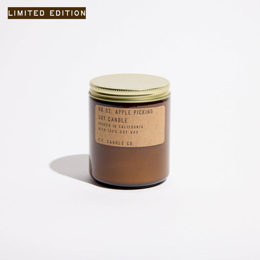 Apple Picking soy candle in an amber glass jar with kraft label and gold lid, Limited Edition tag