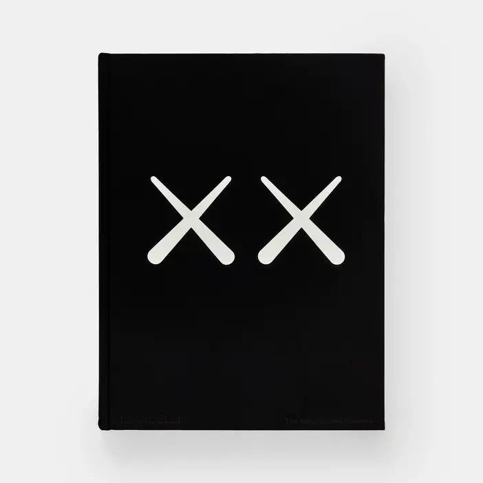 Front cover of Kaws + Warhol, solid black with two large white crossed-bone X shapes