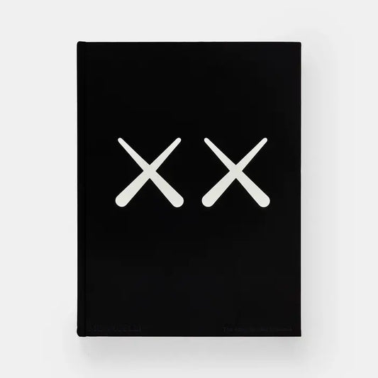 Front cover of Kaws + Warhol, solid black with two large white crossed-bone X shapes