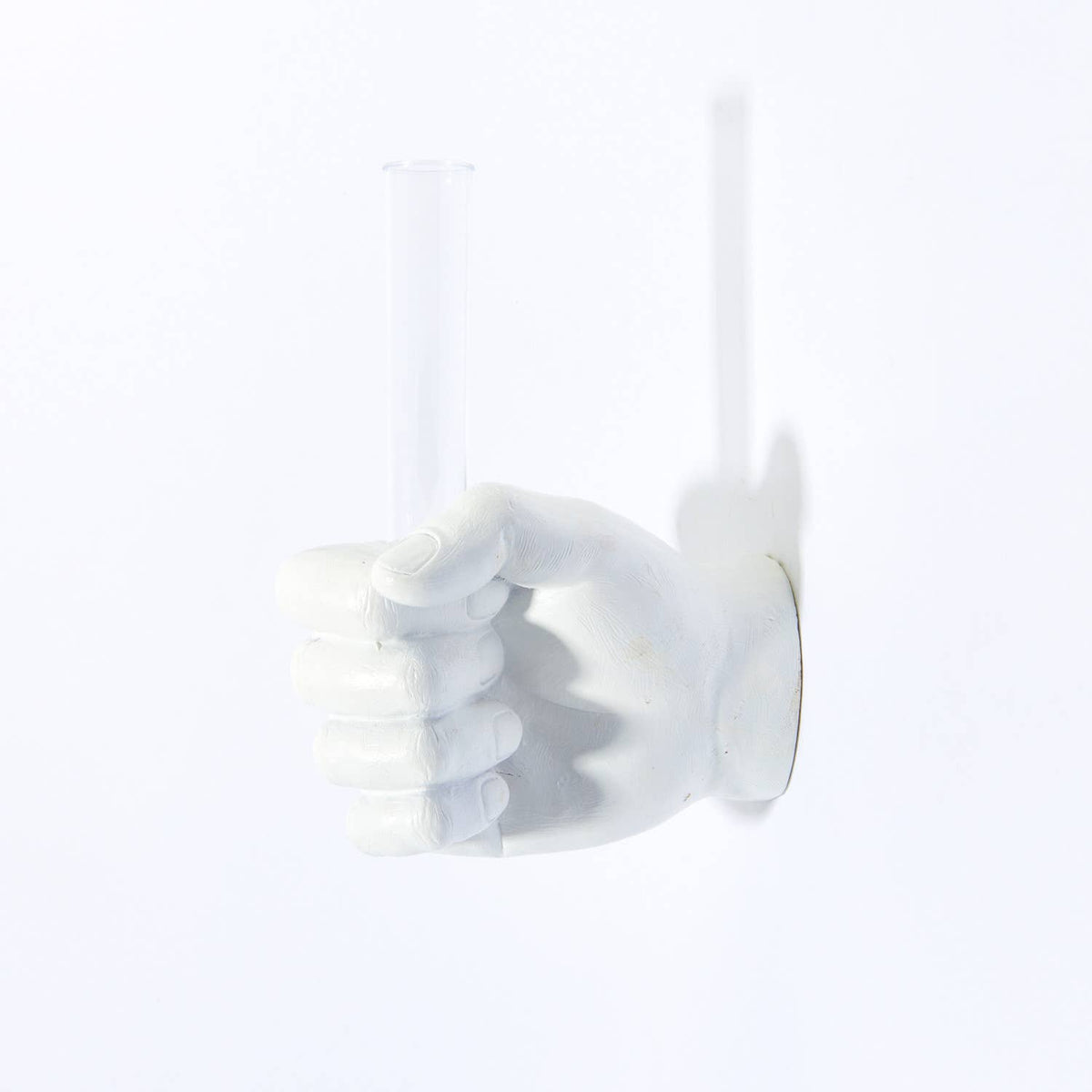 White vase hand wall mount with an empty glass tube, facing left