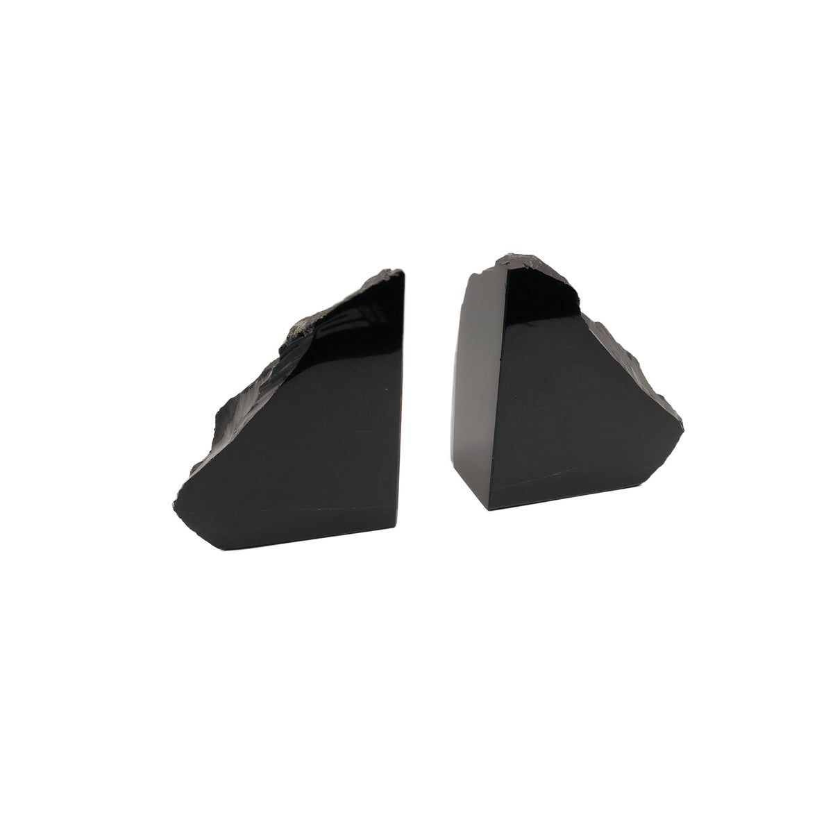 Pair of glossy black obsidian bookends with polished flat faces and rough natural edges