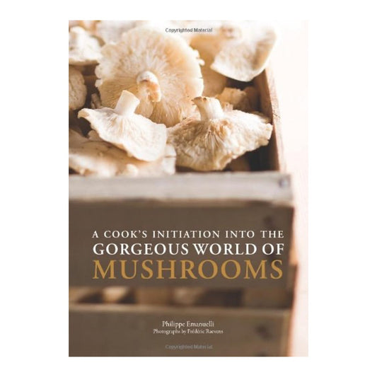 Cookbook cover for A Cook's Initiation into the Gorgeous World of Mushrooms, pale oyster mushrooms in a wooden crate