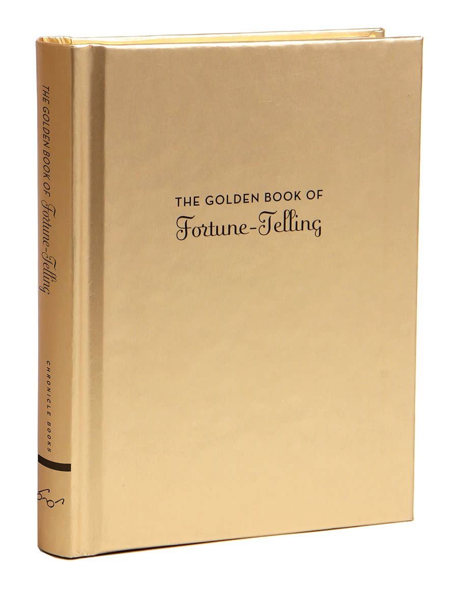 Closer angled view of The Golden Book of Fortune-Telling showing the gold spine and script title