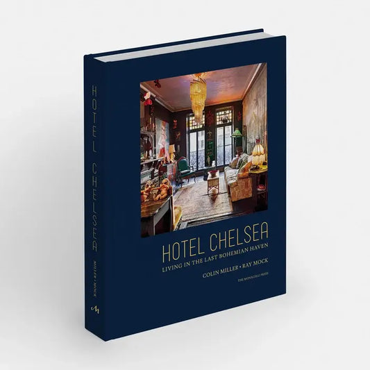 Hotel Chelsea hardcover in navy, angled to show the spine, cover photo of an ornate room with a chandelier