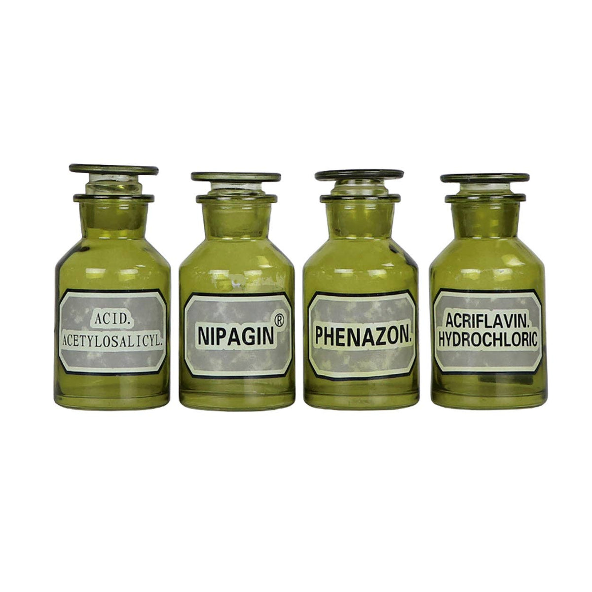 Four green glass apothecary bottles with stoppers and labels like Nipagin and Phenazon