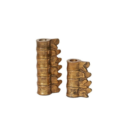 Metal lumbar candle holders in brass finish.