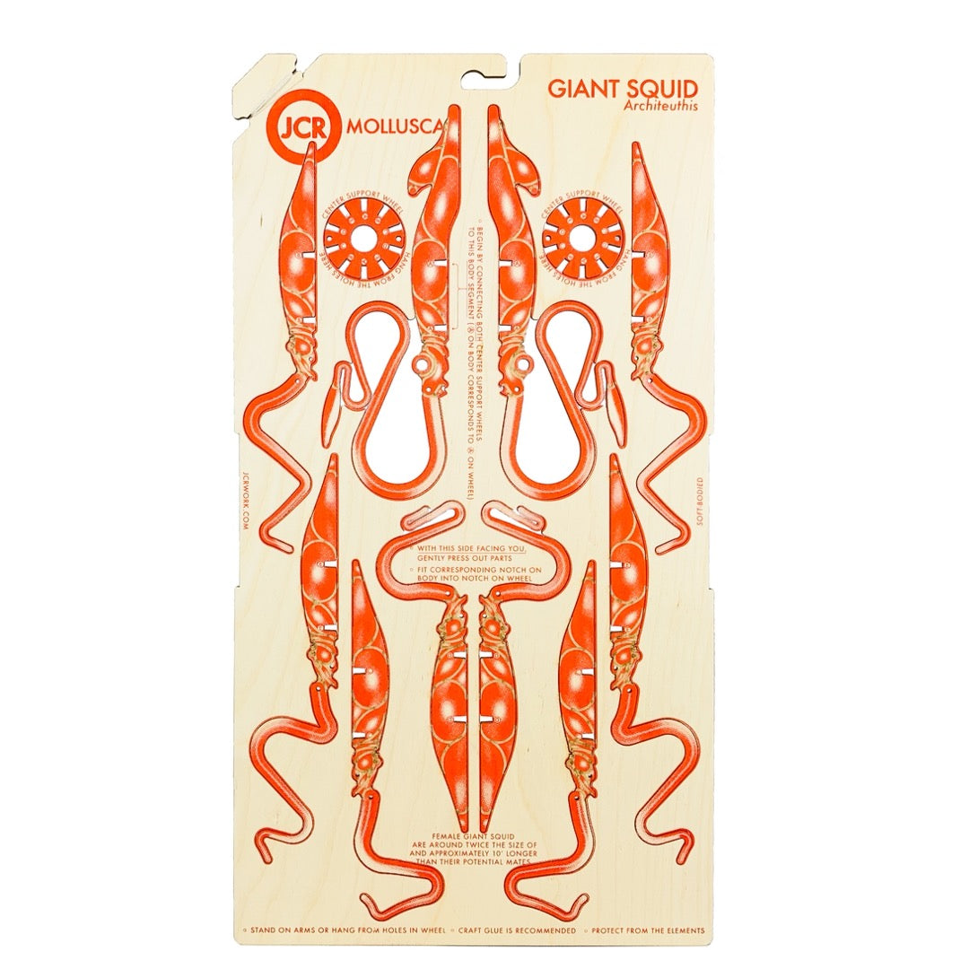 Unassembled Mollusca giant squid wood sheet with orange printed pieces and assembly instructions