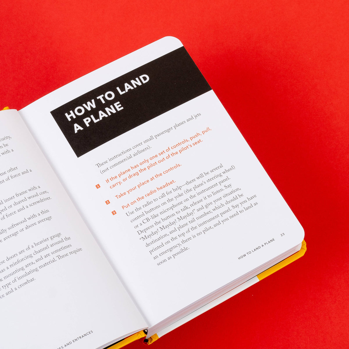 Handbook open to the How to Land a Plane page with orange numbered steps, on a red background