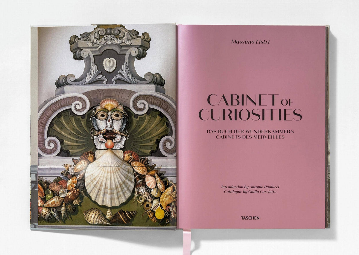 Cabinet of Curiosities opened to a pink title page opposite a seashell-faced figure illustration