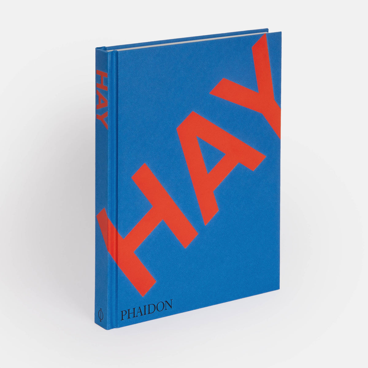HAY book by Phaidon standing upright, blue cover with large red HAY lettering