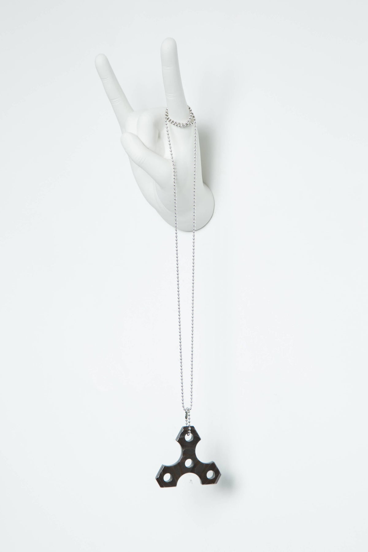 Rock On hand hook with a ring and long ball-chain necklace hanging from one finger