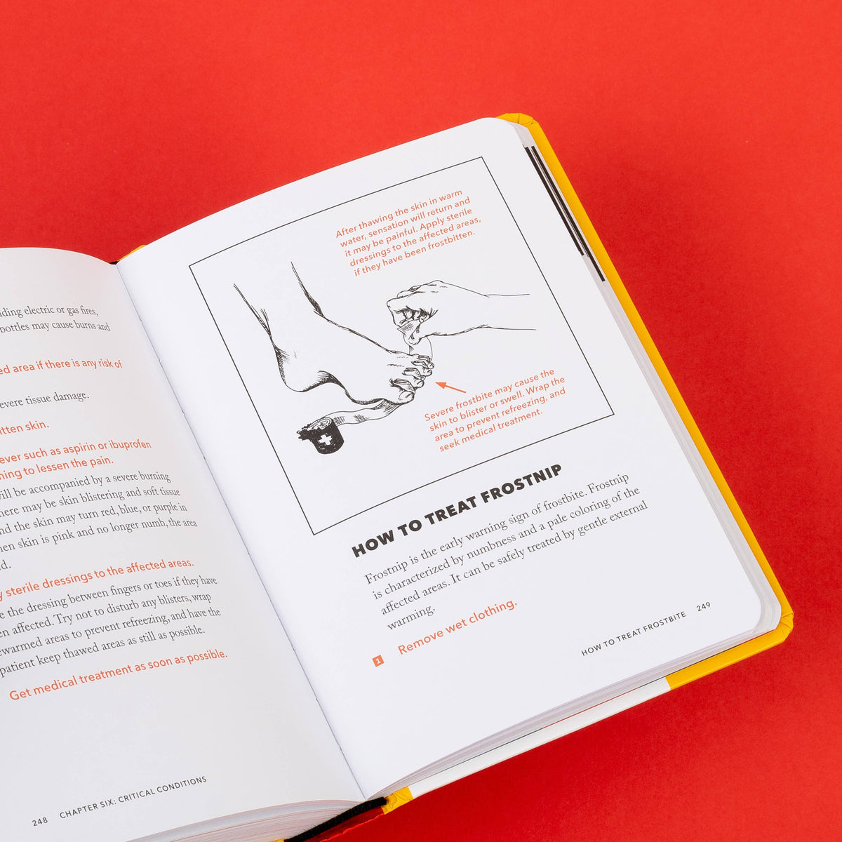 Handbook open to How to Treat Frostbite with a drawing of hands warming a bare foot