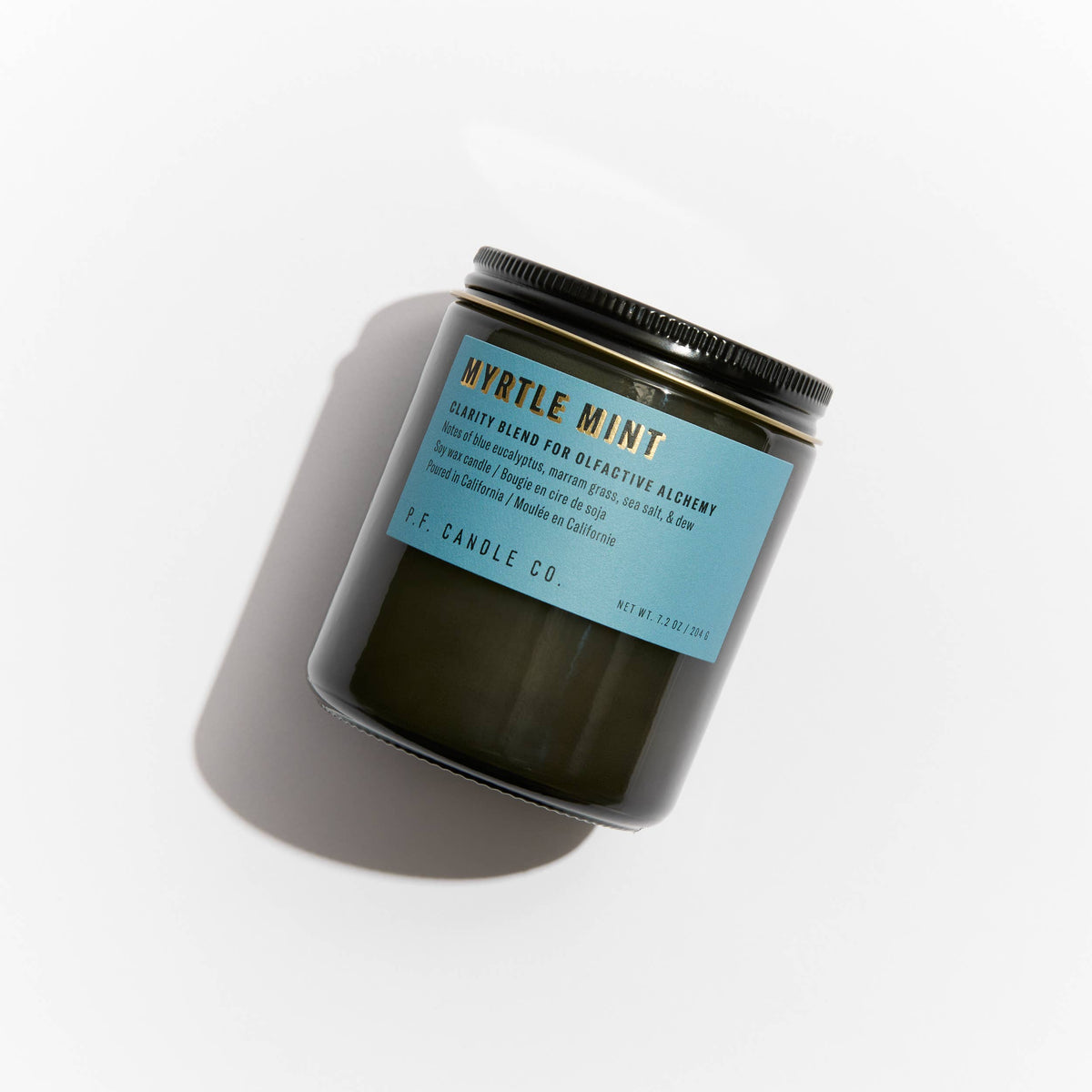 Myrtle Mint candle in a dark glass jar with black lid and blue label, viewed from above