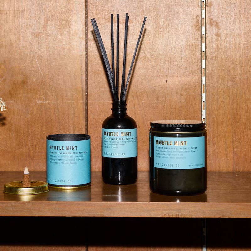 Myrtle Mint set on a wood shelf: incense tube, reed diffuser and large jar candle with blue labels