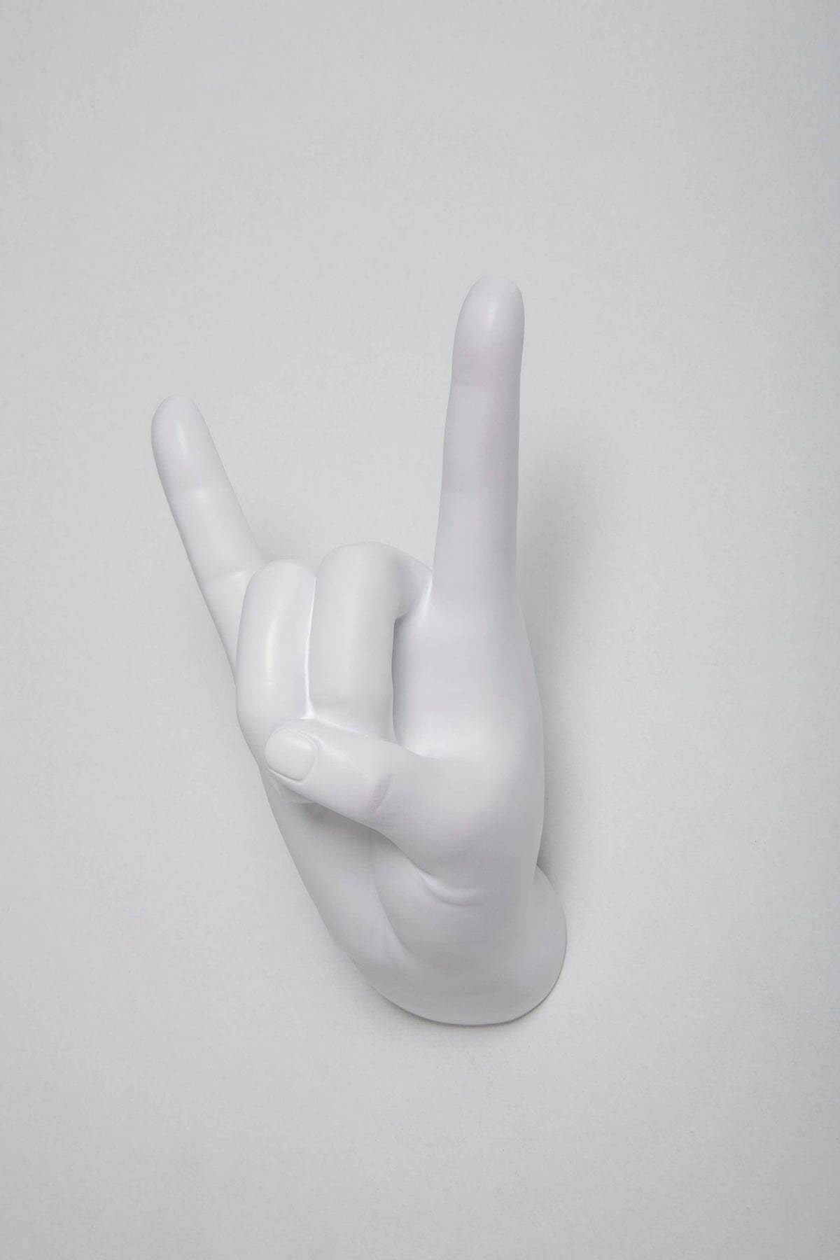 White Rock On hand hook viewed straight on, index and pinky fingers raised