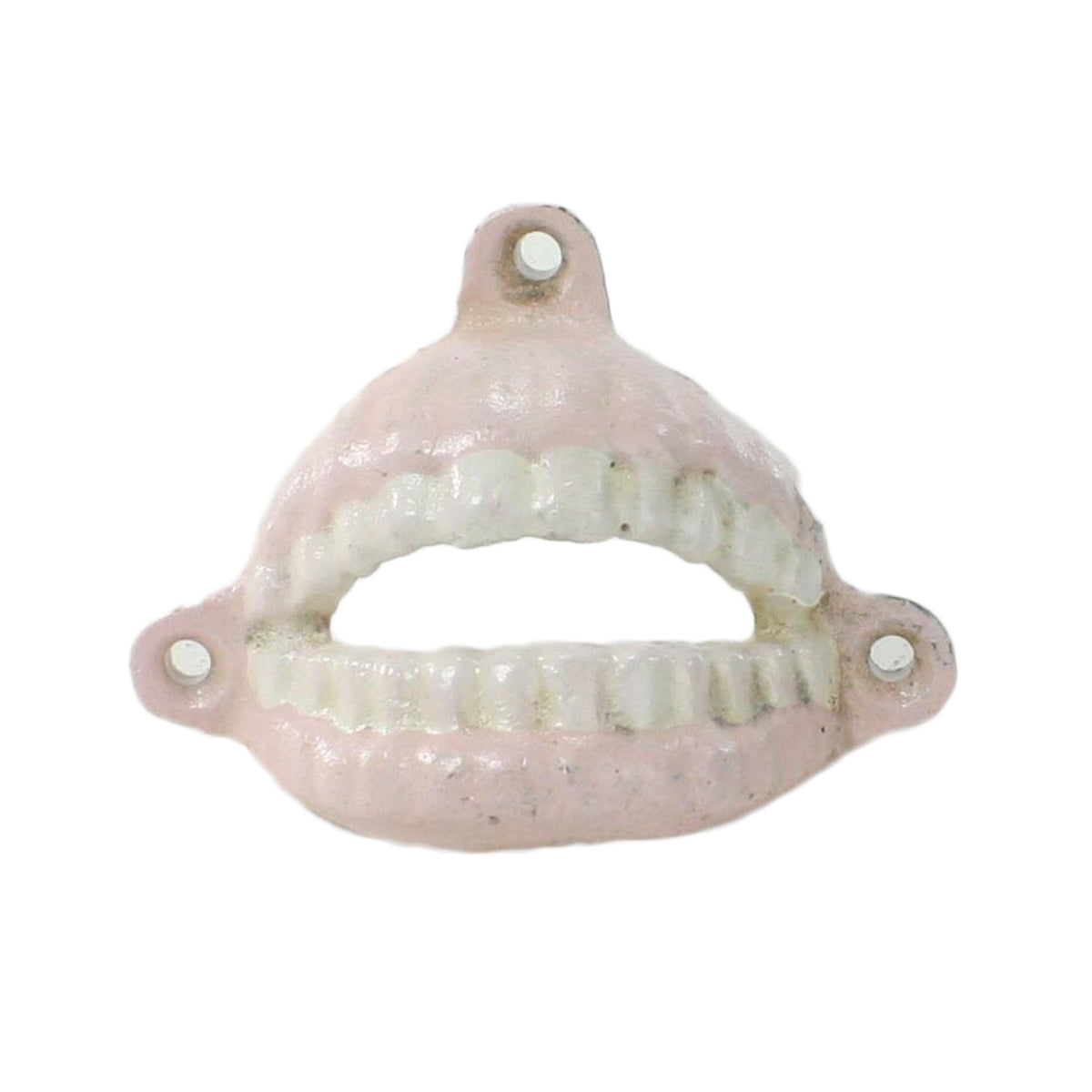 Pale pink and white cast iron denture bottle opener with three mounting holes, front view