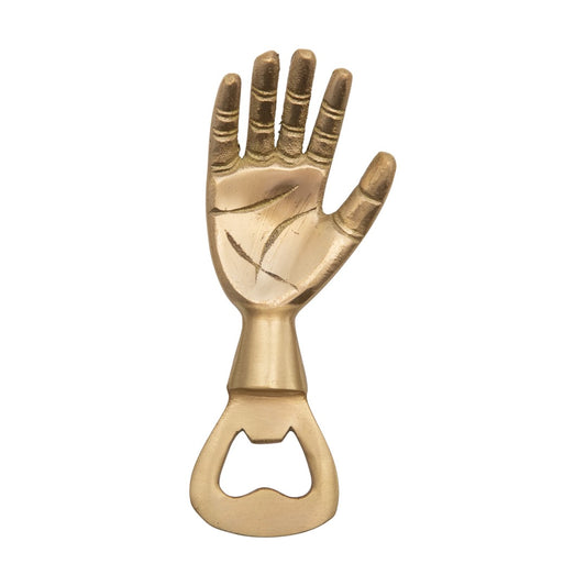 Brass hand bottle opener shaped like an open palm with etched lines, opener at the wrist