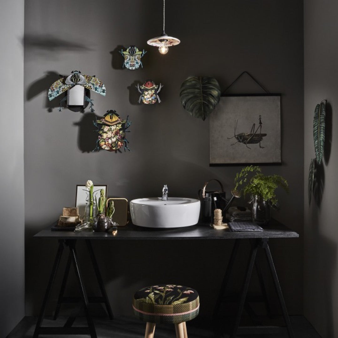 Collection of beetle wall cabinets on gray above bathroom sink 