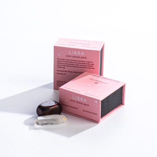 Libra mini stone pack text on pink boxes with Libra constellation pattern. Clear quartz and polished bloodstone stones in front. 