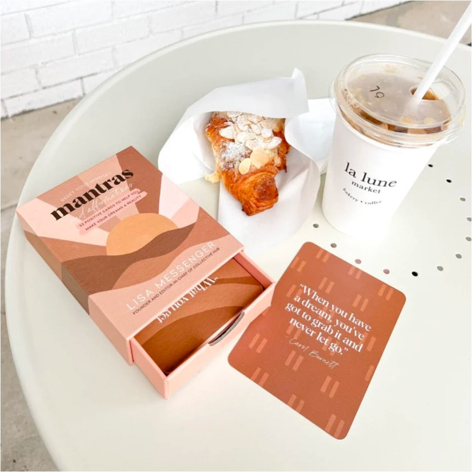 box cards with drawer pulled out on table next to croissant and drink.