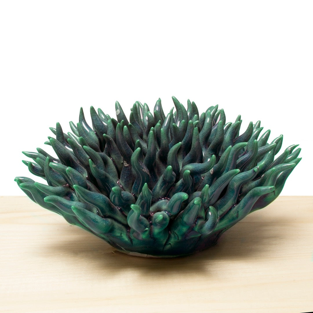 Ceramic sea coral in green, side view.
