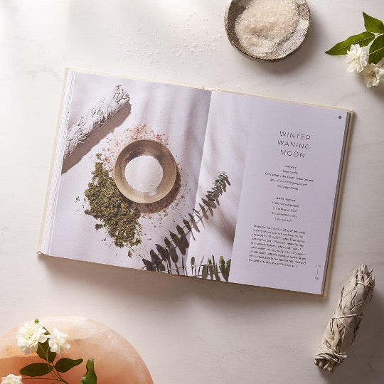 Moon Bath open to the Winter Waning Moon ritual, styled with a sage bundle, bath salts and white flowers