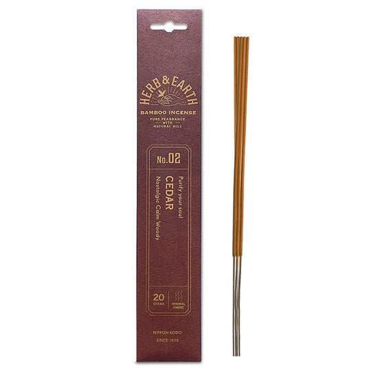 burgundy package with gold text and three incense sticks on right.