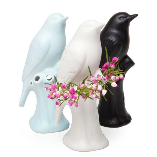 baby blue bird planter, matte black bird planter, and matte white bird planter with fresh flowers