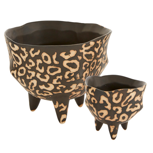Leesi pots in two sizes, footed ceramic bowls with matte black finish and tan animal-print pattern